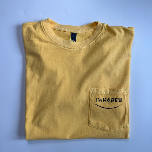 yellow folded t-shirt with be happy on the pocket. 